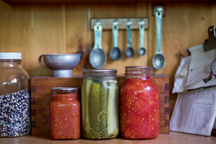 Colorful preserves await in the wood-paneled kitchen.