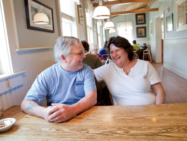 Patty and John Reagan, photo­graphed here in Dot’s Restaurant’s rebuilt dining room, were initially reluctant to rebuild. Community support convinced them other­wise, and they reopened for business on December 12, 2013.
