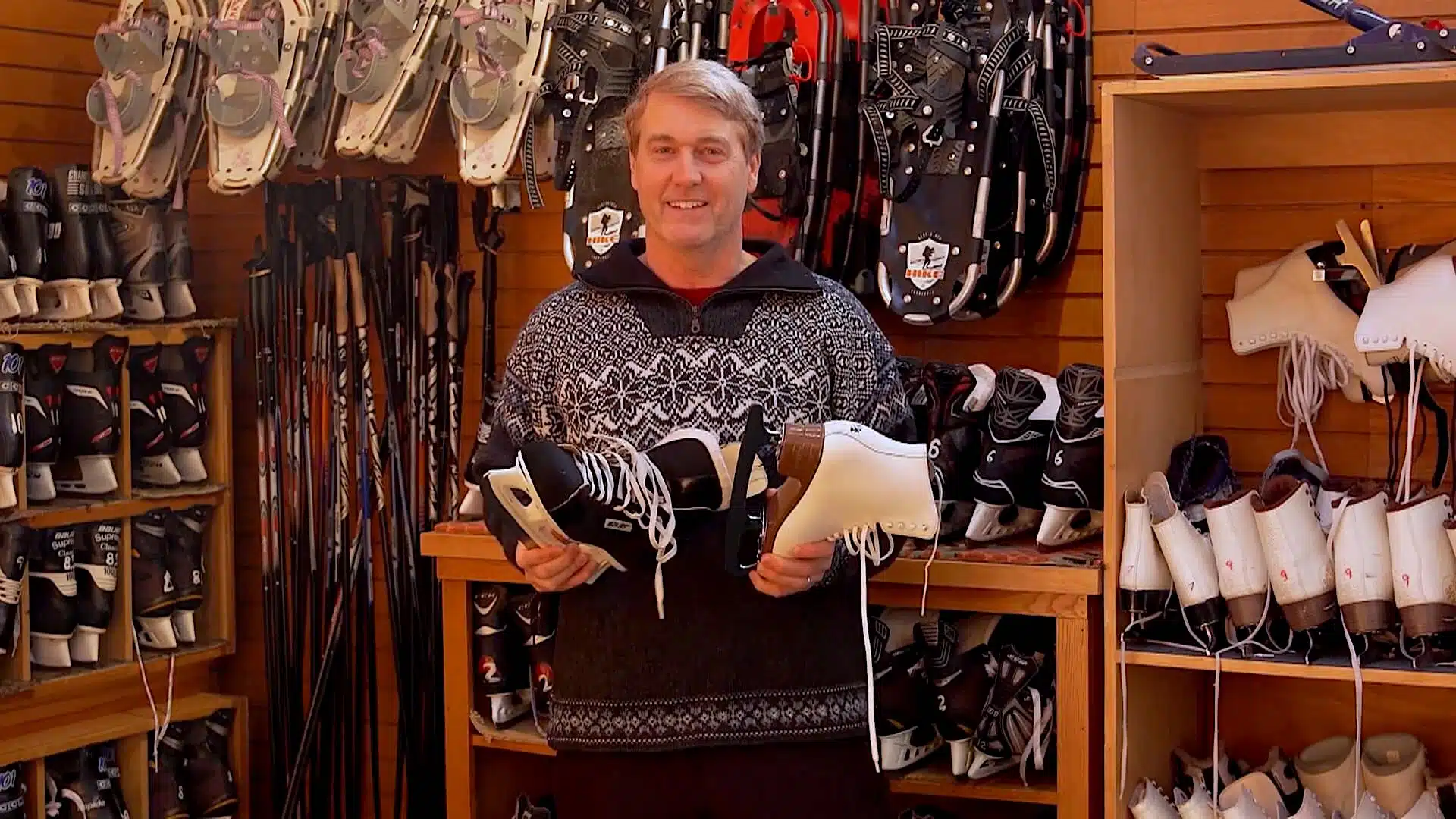 Richard weise holding two pairs of ice skates.