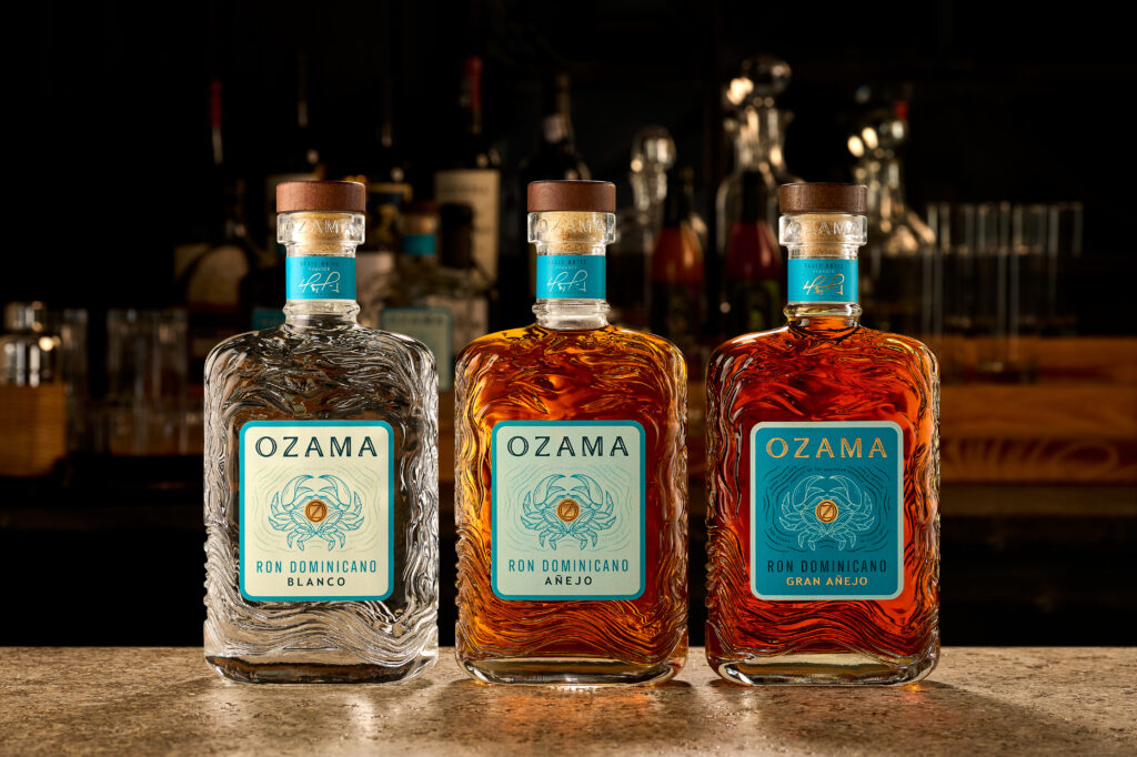 Three bottles of Ozama rum—Blanco, Añejo, and Gran Añejo—displayed on a bar counter. New England gifts for dad