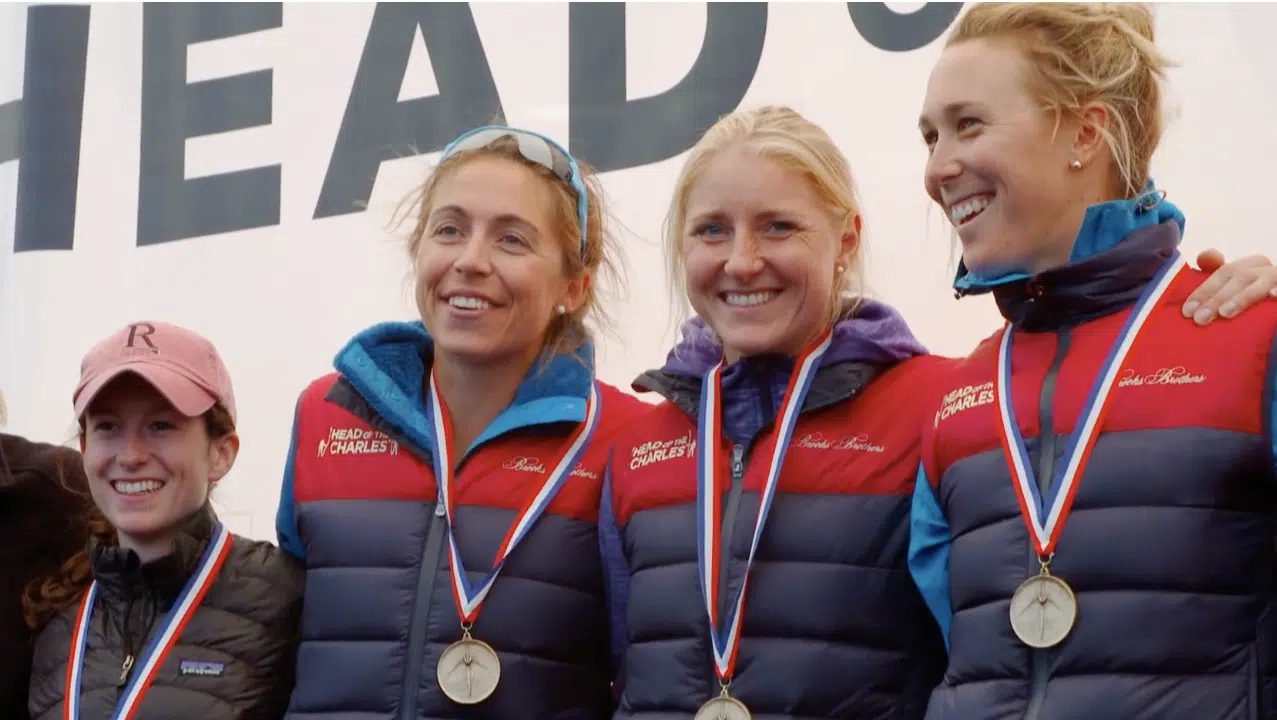 Olympic rower Gevvie Stone alongside her teammates at head of the charles rowing event.