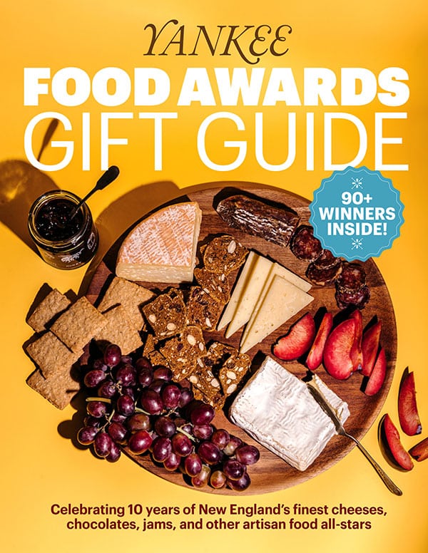 Cover of Yankee Food Awards Gift Guide featuring an assortment of cheeses, grapes, bread, and chocolate on a wooden board.