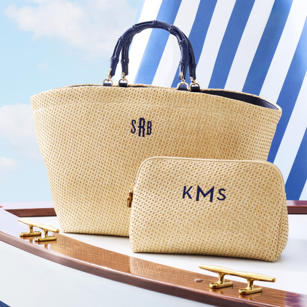 Mark & Graham tote bag with monogram and a matching pouch displayed on a boat.