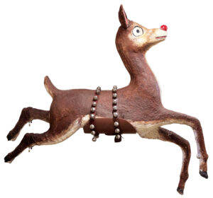 A leaping reindeer decoration with a red nose and a brown harness decorated with bells.