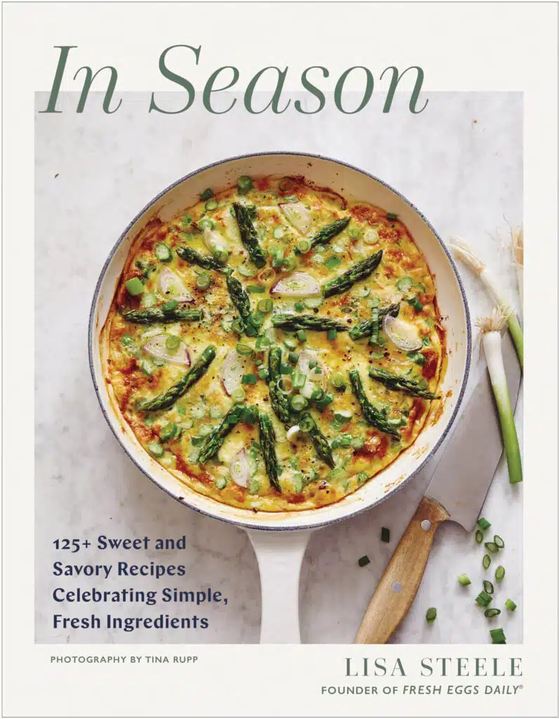 Book cover for "In Season" with a vegetable frittata in a skillet, garnished with asparagus, radishes, and green onions.