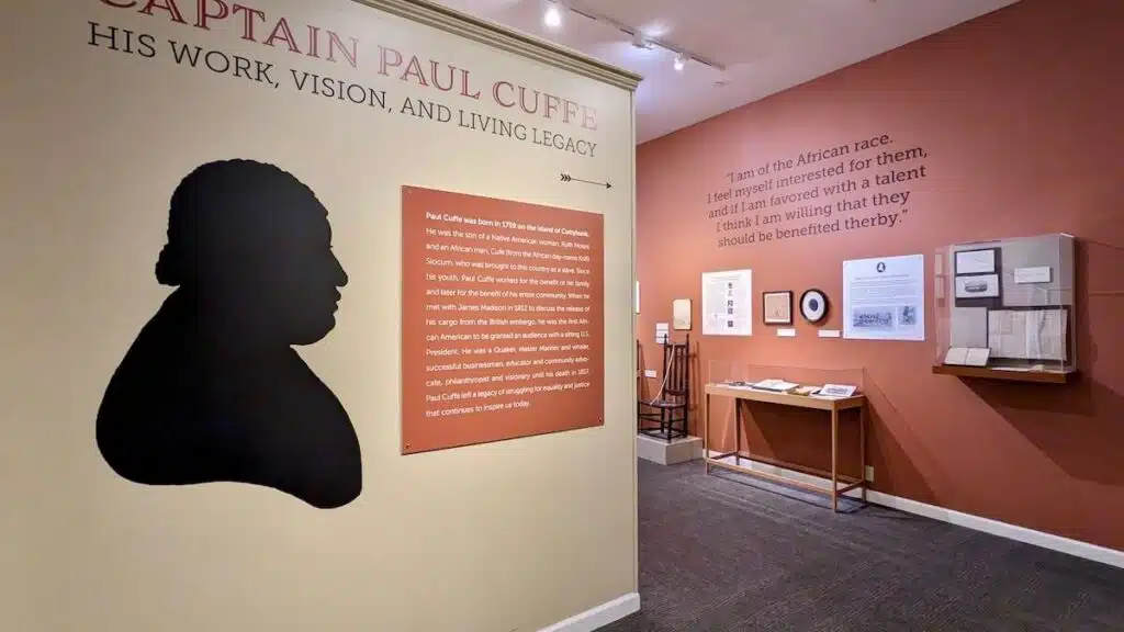 Museum exhibit about Captain Paul Cuffe, featuring text, artifacts, and a black silhouette of his profile.