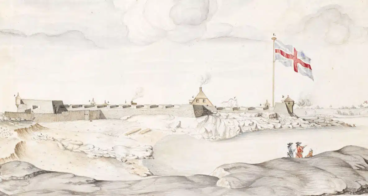 Historical fort by the water with a large flag, three people in foreground, and smoke rising in the distance.