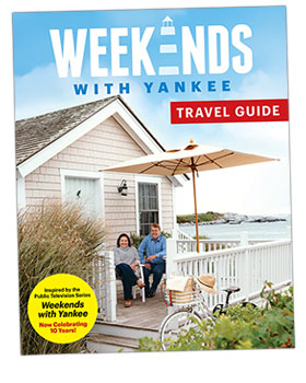 Couple relaxing on a porch by the sea on the cover of "Weekends with Yankee" travel guide.