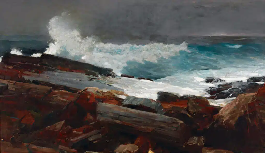 Waves crash against rocky shore under a dark, cloudy sky; sea spray and logs are scattered on the rocks.