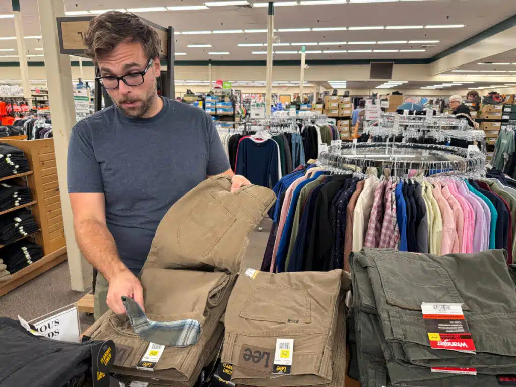 Man shops for fleece-lined pants at the Renys department store in Saco, Maine.