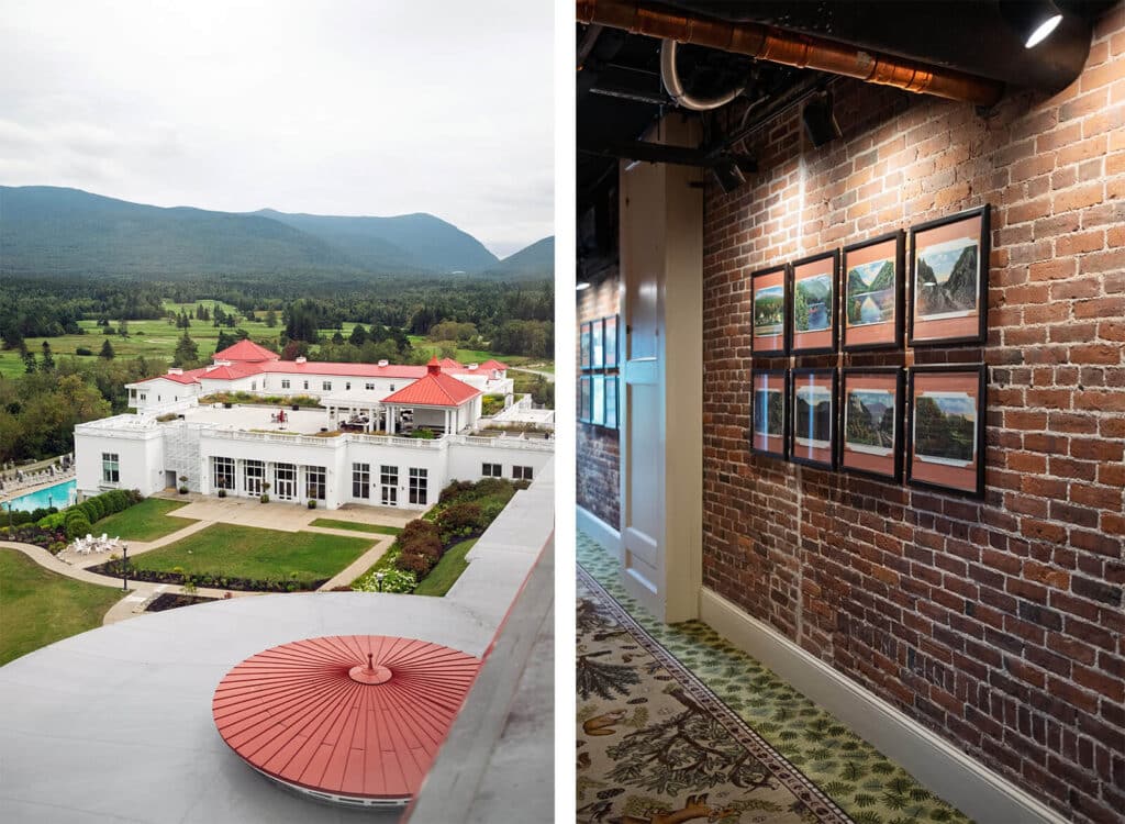 A white resort with red roofs, mountains in background, and framed photos on a brick hallway wall.