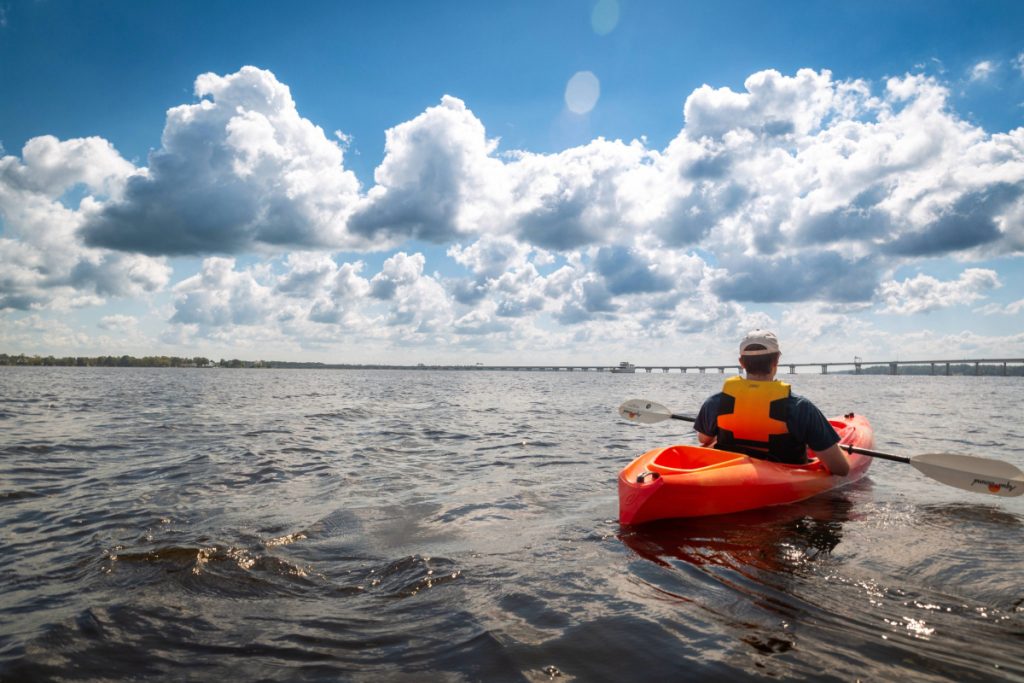 Person kayaking on an autumn day in New Bern, NC.