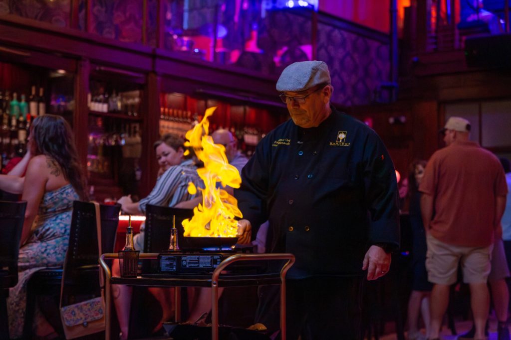 A chef at Baxter's 1892 restaurant prepares a flaming dish tableside.