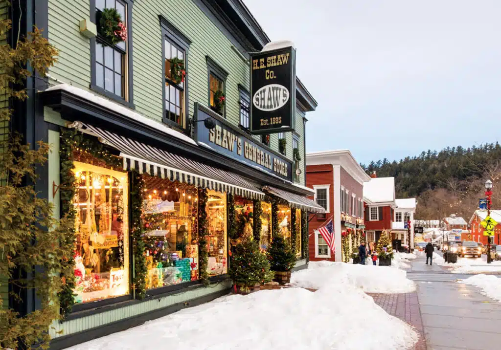Christmas in Stowe, Vermont | A Magical Holiday Getaway. Shaw’s General Store decorated for Christmas on a snow-covered street.