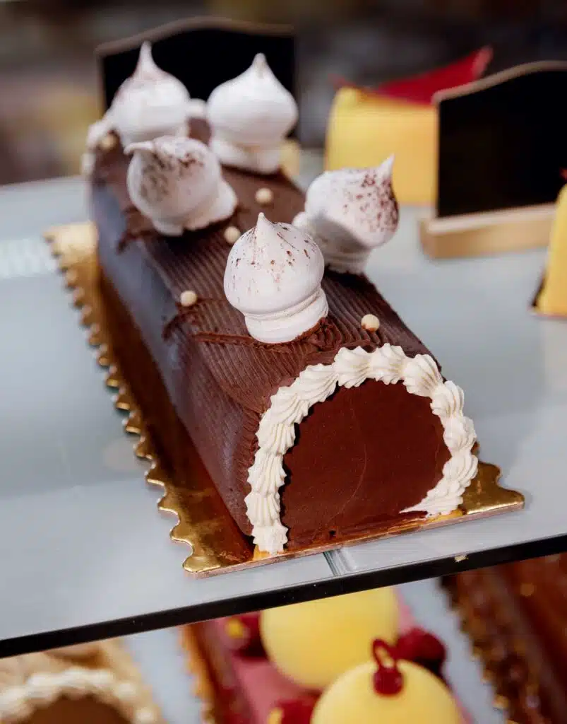 Chocolate yule log cake topped with meringue kisses.