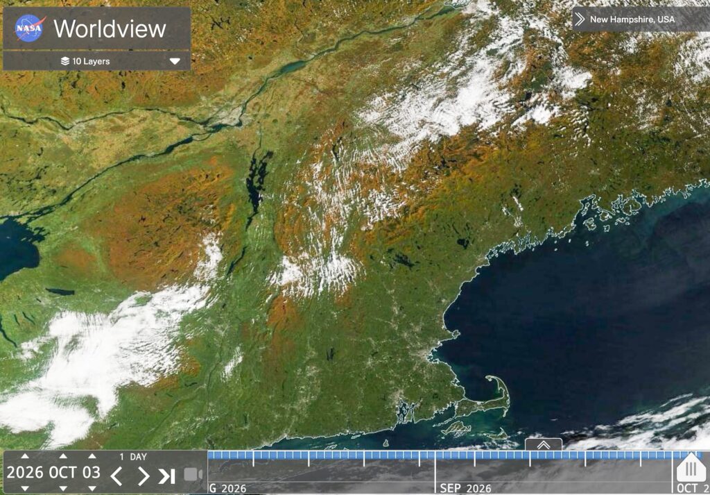 Satellite view of New England showing autumn foliage and cloud cover.