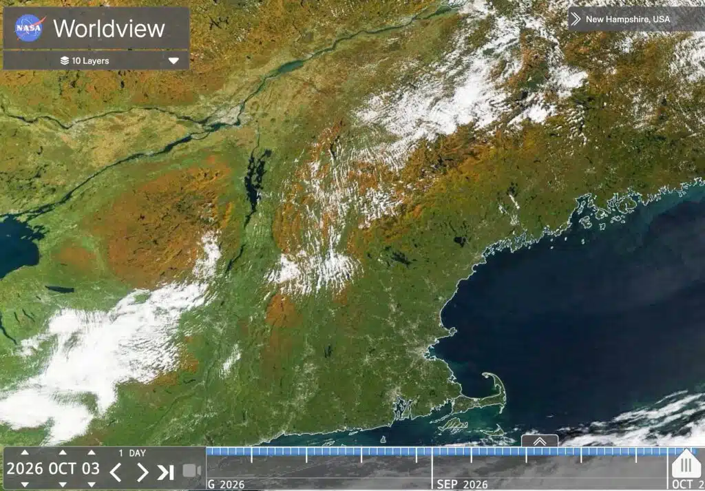Satellite view of New England showing autumn foliage and cloud cover.