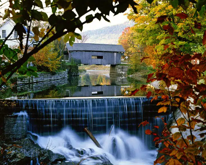 Foliage surrounding the Warren Covered Bridge in Warren, Vermont.