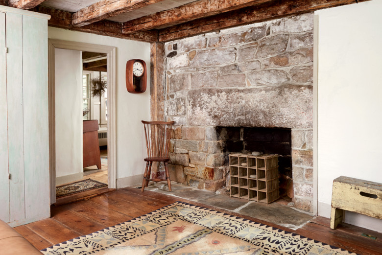 In one of the front rooms, an original granite hearth becomes an eye-catching display space.