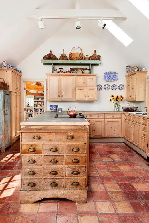 Italian and Portuguese pottery lends a splash of color to the kitchen, which is anchored by a floor of handmade Mexican tile. 