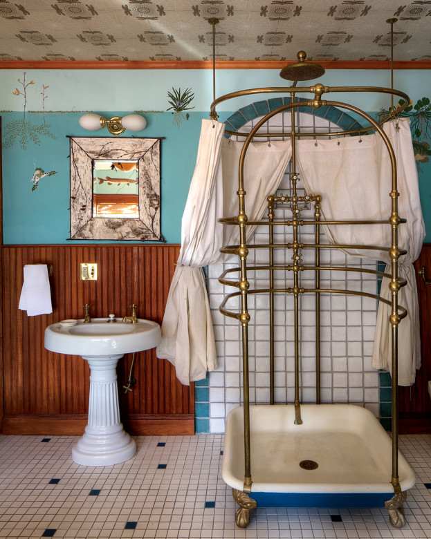 A bathroom featuring a Victorian cage shower and a mural by Goodrich.