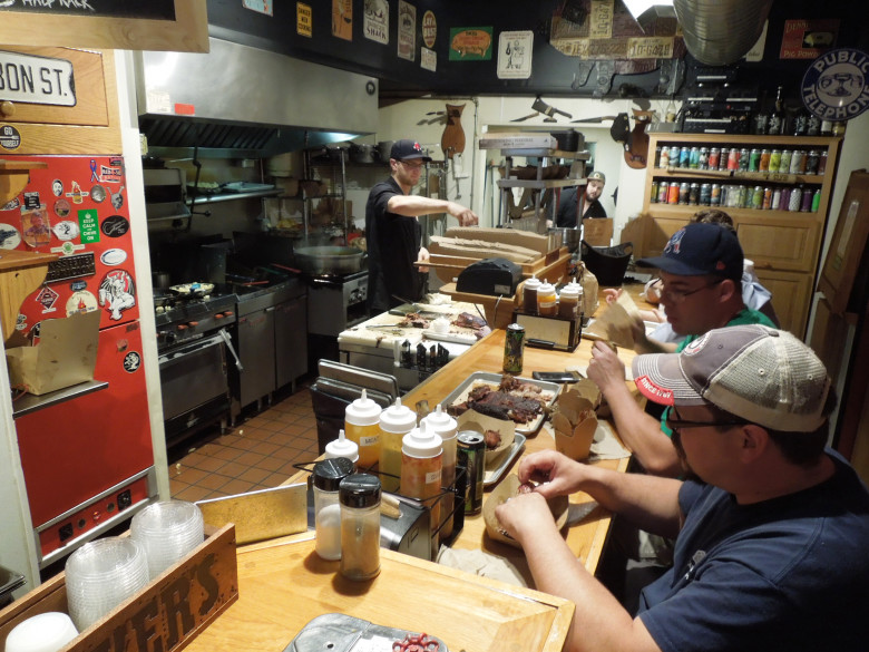 The coveted four-stool counter overlooking the kitchen and carving station at B.T.’s Smokehouse. 
