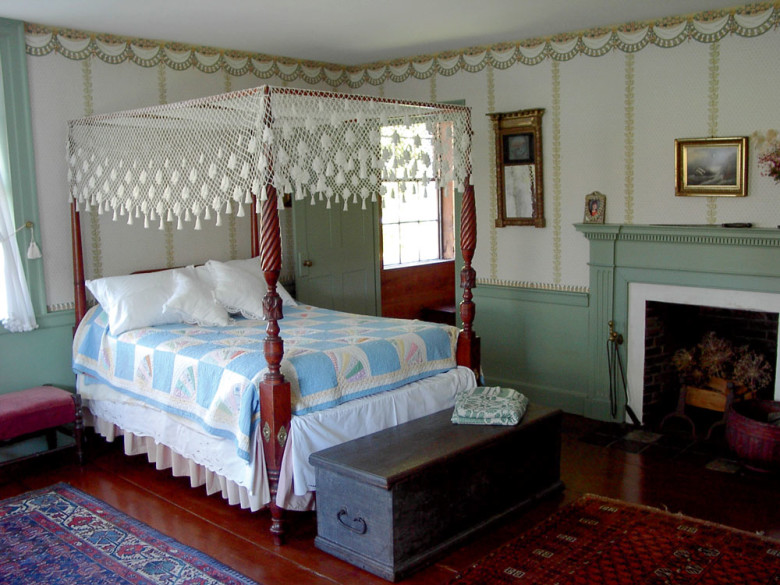 The bedroom features one of seven fireplaces. 