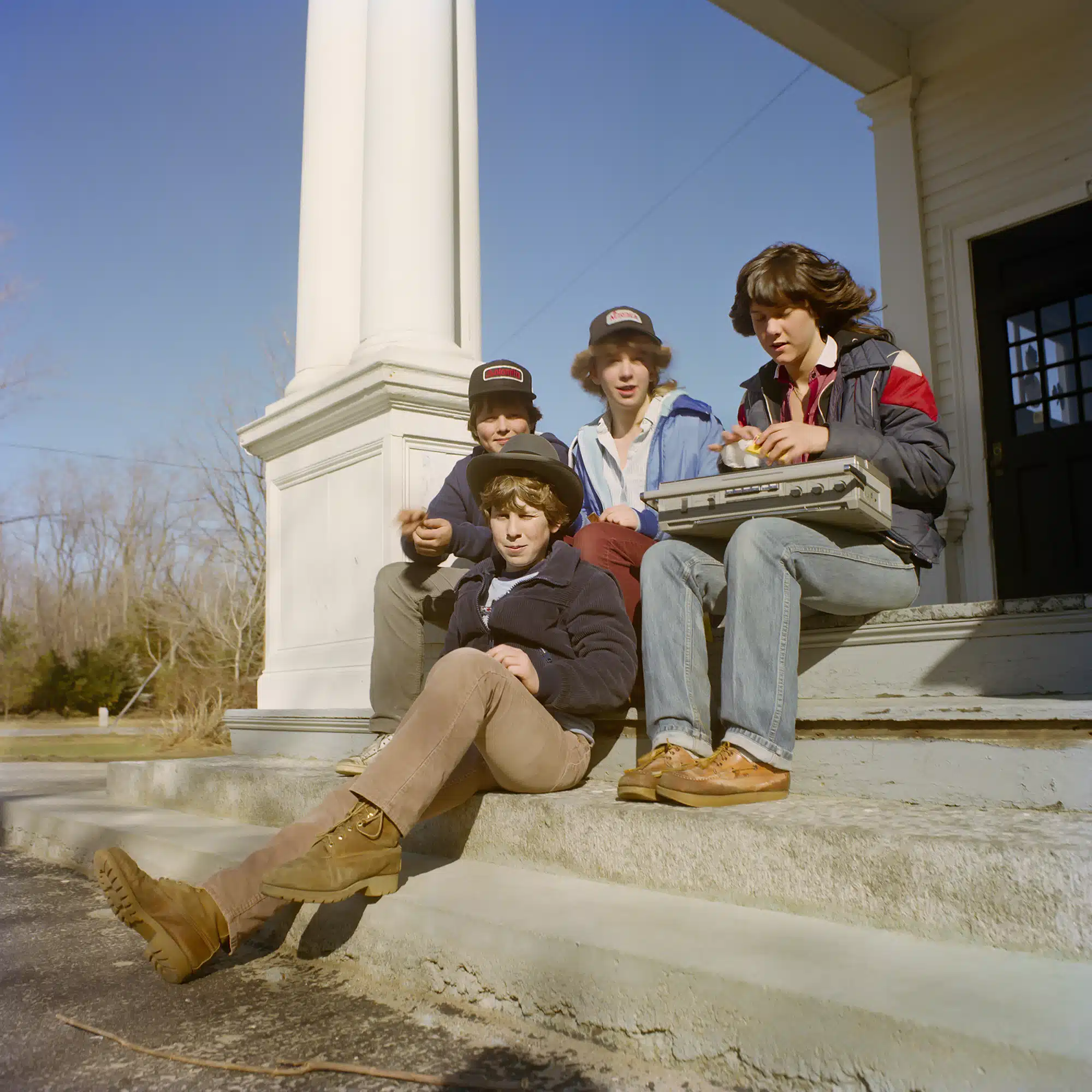 Boombox - 1983 "I was walking through the center of town and ended up at my old school (Frost School) that I walked to for five years to attend first grade through 5th. We all walked to school back then, in the rain, snow or sleet. There was a single classroom for each grade and there were two porches where we used to run and play and also upon occasion put on plays and skits. On this day there was a small group of young teens, some that I knew, just hanging out listening to a big….wait for it….boombox! Yup, those were the days of buying and playing cassettes and crusin the town in small groups to just hang out."