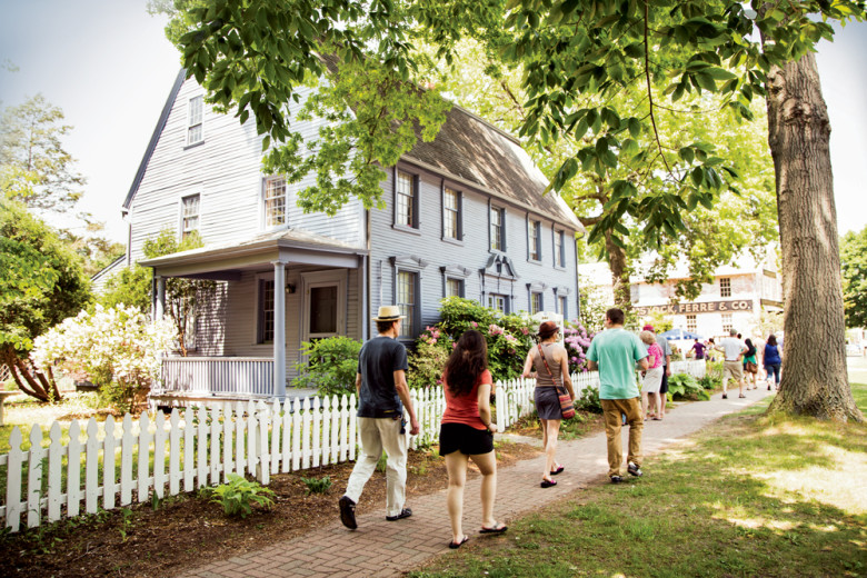 A walking crowd hits the bricks alongside the Simeon Belden House, one of Main Street’s 18th-century gems.