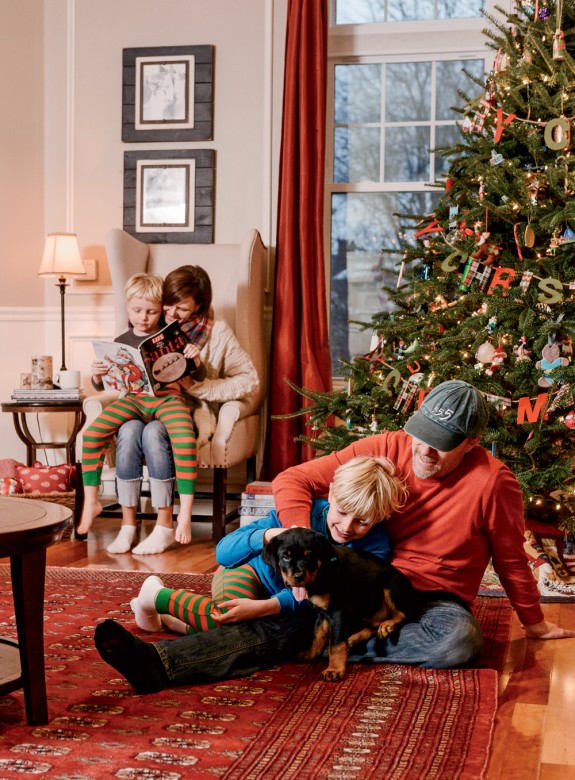 The Corrys at Christmas: Michelle and Finnigan read about the origins of Santa Claus as Steve and Seamus play with Einstein (a puppy when this picture was taken, “he’s now almost 100 pounds!” Michelle reports).