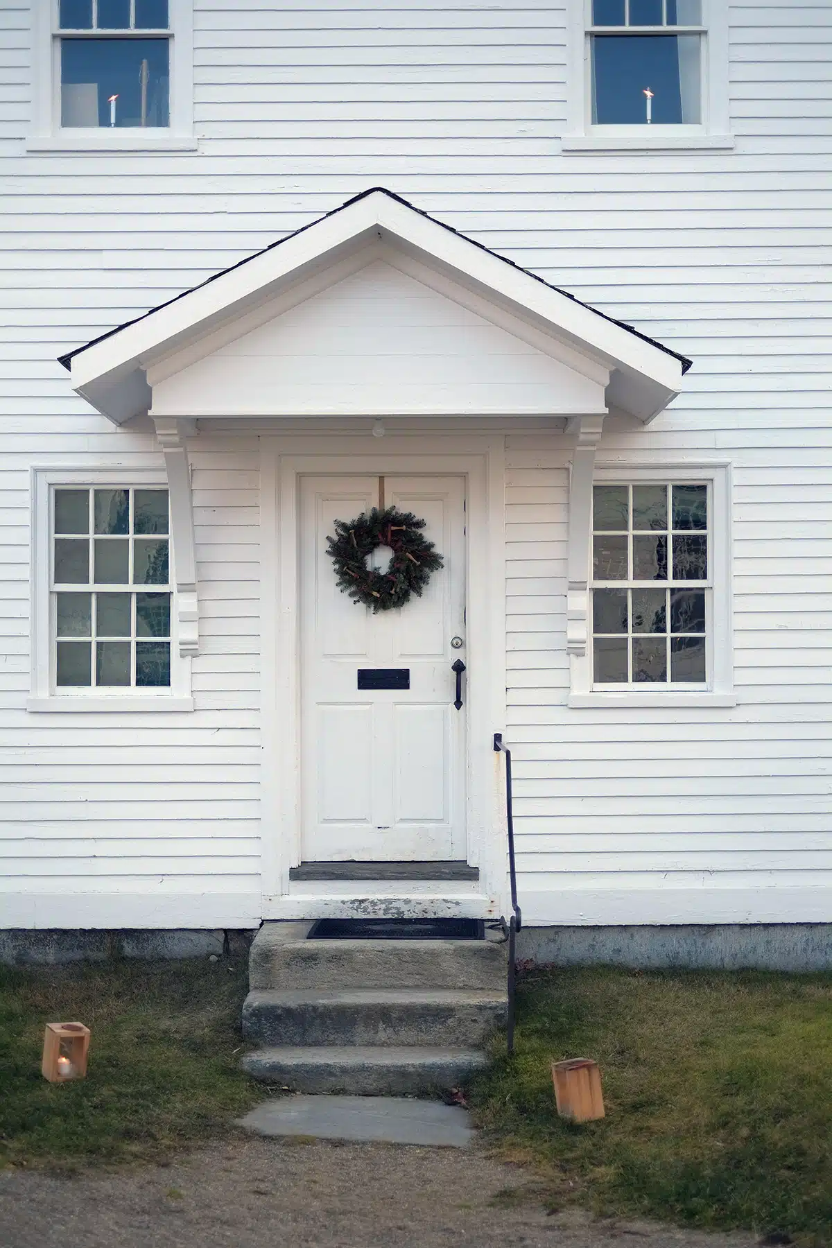 A simple holiday wreath adorned with wooden pegs, berries and ribbon at the Brethren's Shop.
