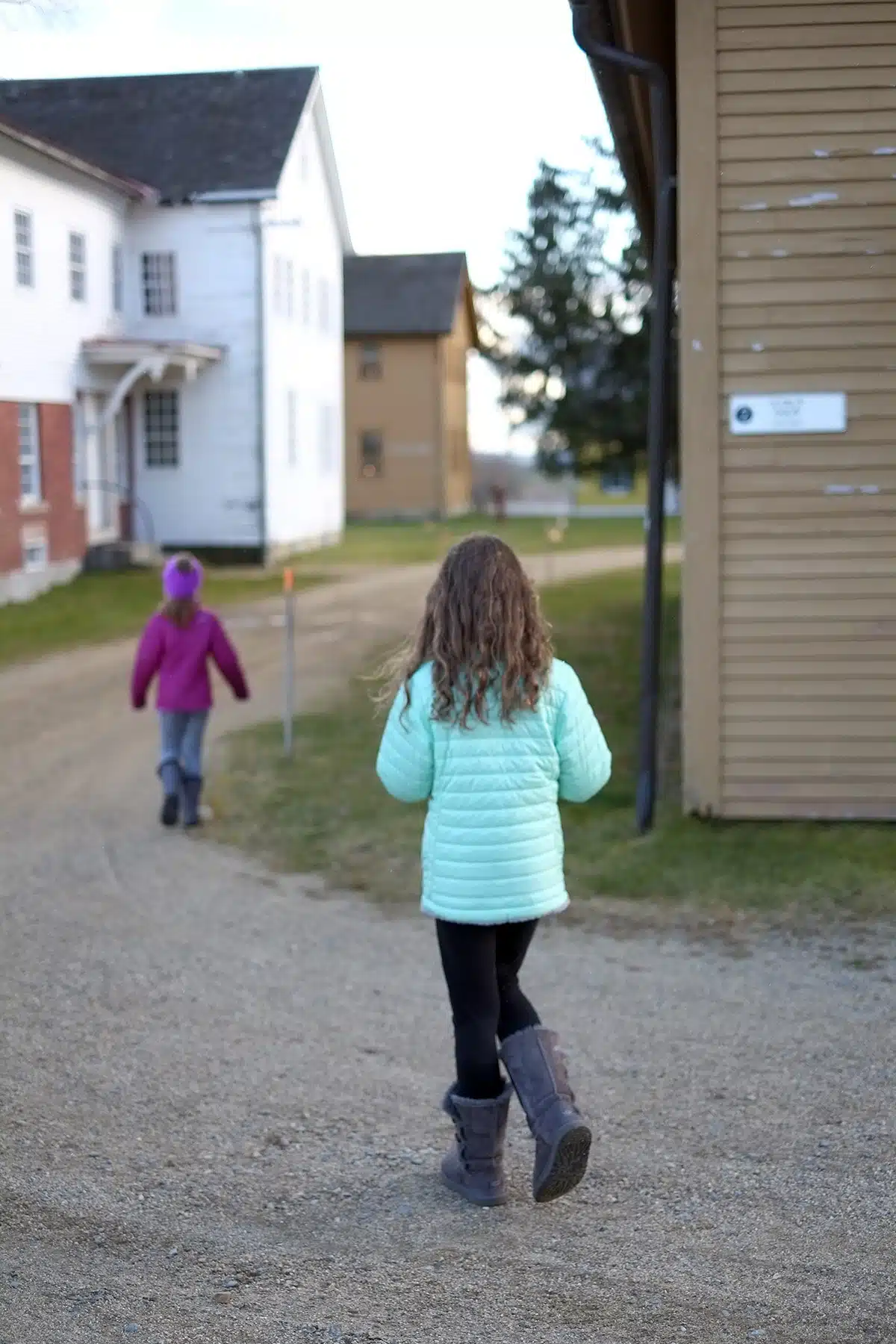 A dirt path leads the girls past the Creamery.