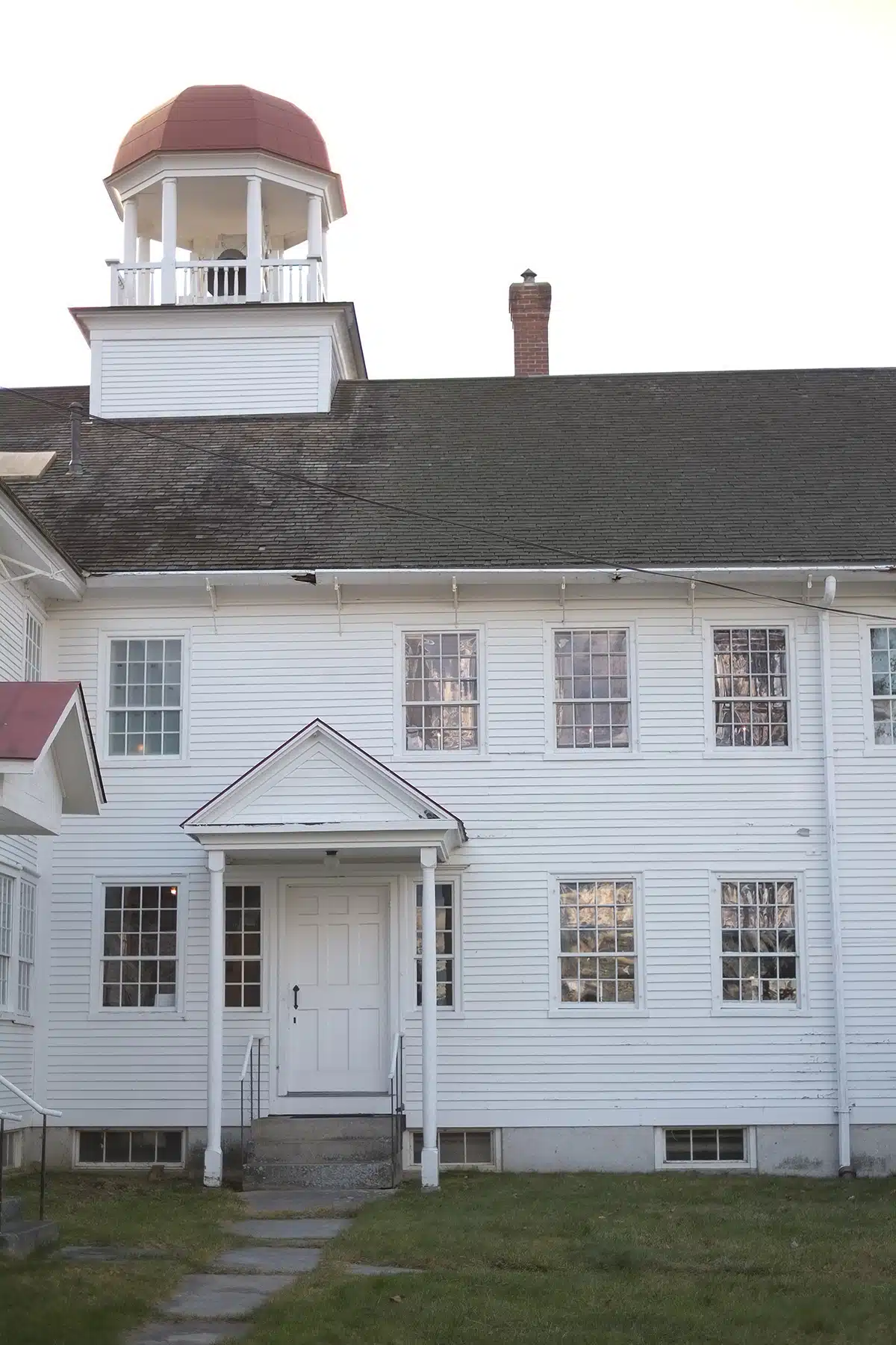 The exterior of the Dwelling House with a bell tower on top(tk).