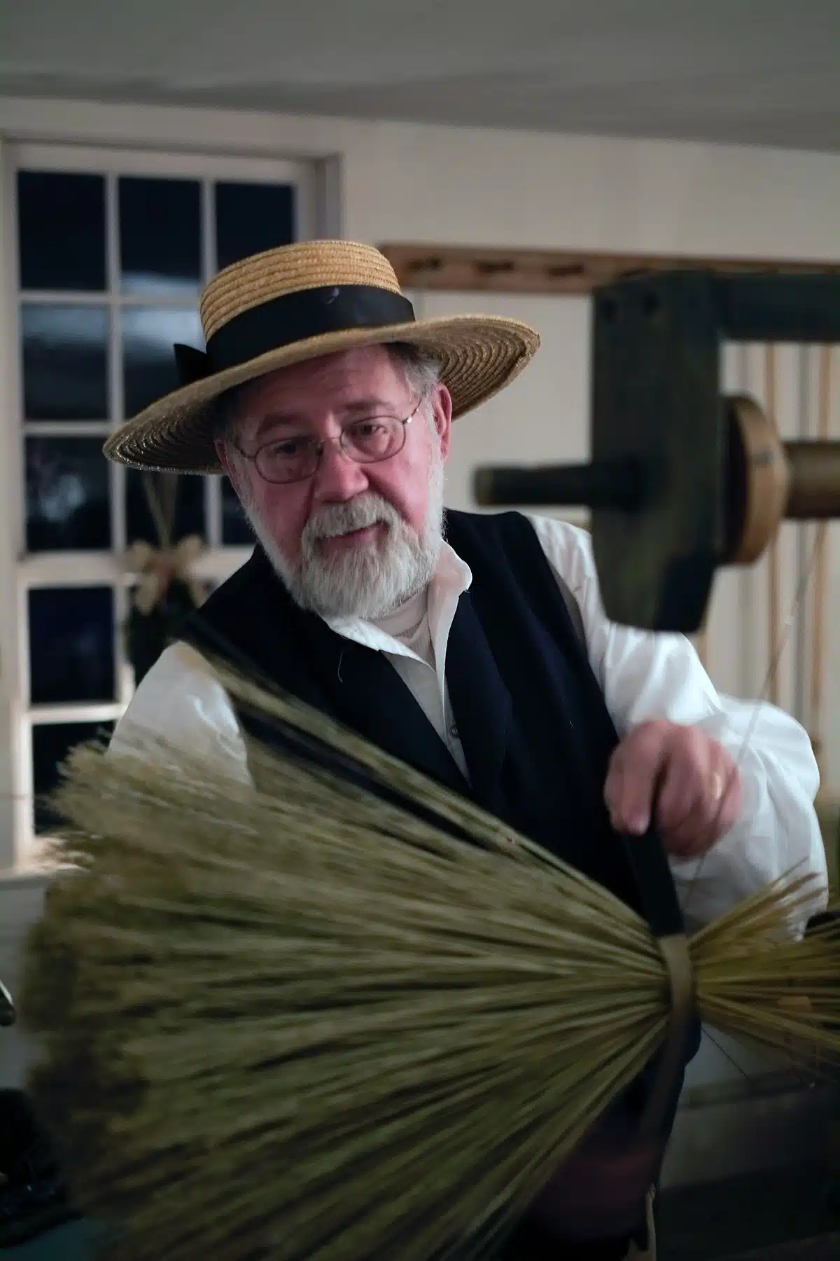 Everett Bailey demonstrates the art of broom making in the Carpenters' Shop.