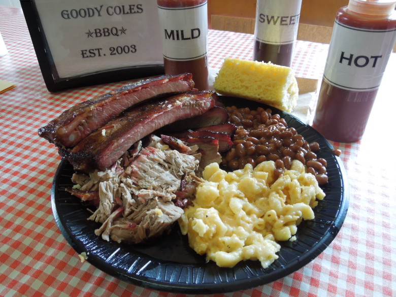 A Goody Coles barbecue combo plate with three meats, two sides, and a slab of corn bread. 