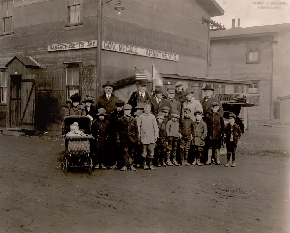 In this November 1918 photo, Massachusetts Governor Samuel McCall (center, in bowler hat) pays a visit to a temporary housing complex bearing his name. Home to more than 2,000 people, it was erected on Halifax’s exhibition grounds in 320 working hours.