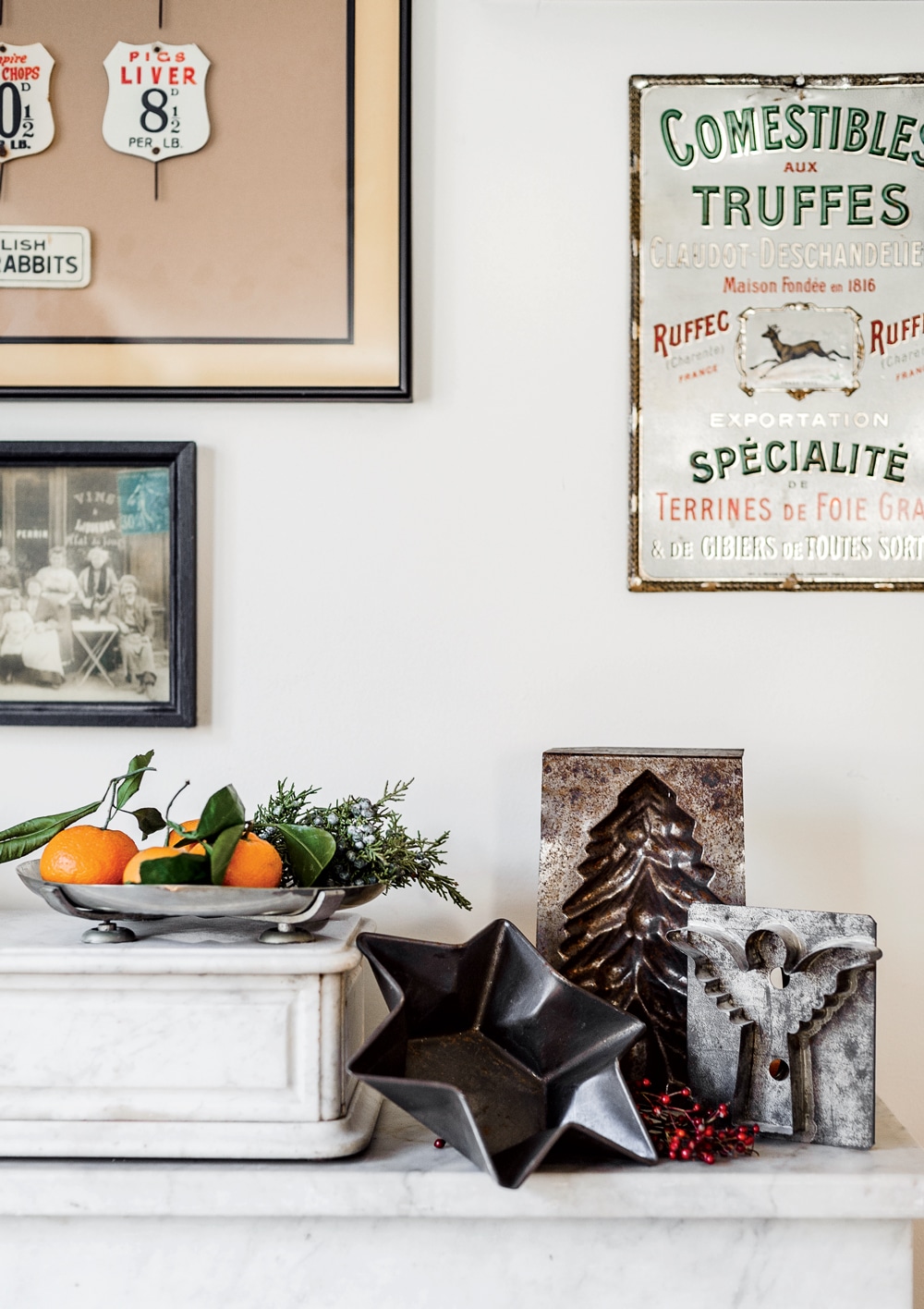 Among the culinary artifacts that fill the Brass sisters’ Cambridge, Massachusetts, home: assorted vintage metalware and an early 20th-century French specialty-foods sign. 