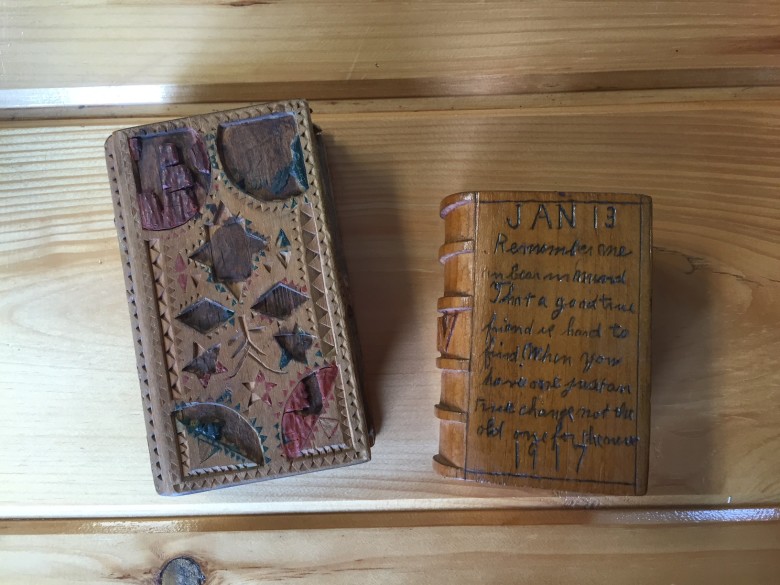In the evening hours, after supper, lumbermen filled the time playing games, writing letters, and creating folk art, like these spruce gum boxes. These boxes often featured intricate designs and poetry, with a sliding top to prevent the gathered spruce gum from falling out. 