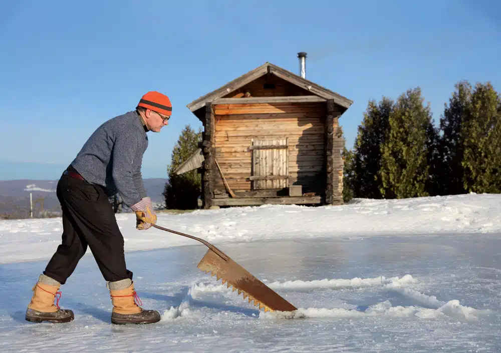 Eric Aho makes the final cut for his avanto, a Finnish “plunge pool,” with a c. 1900 ice saw from his cache of antique ice harvesting tools.