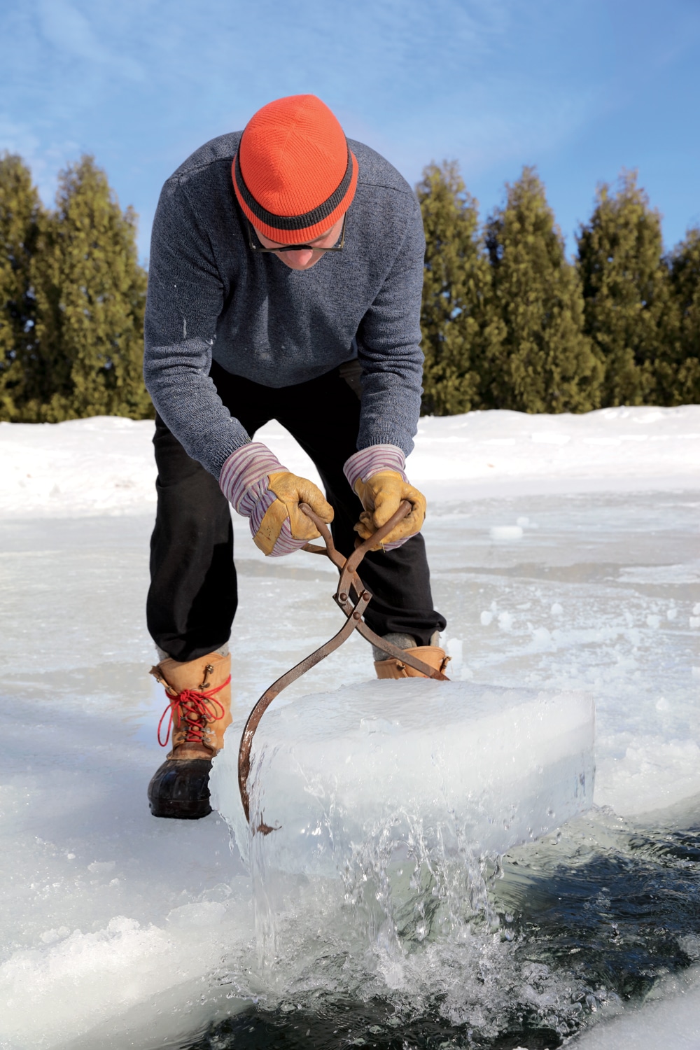Clearing ice with vintage tongs capable of holding two-foot-wide blocks.
