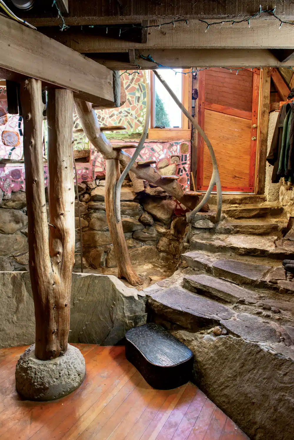 Ceramic wall mosaics created by Philadelphia artist Isaiah Zagar add a dash of color to the stone and wood inside the entrance.
