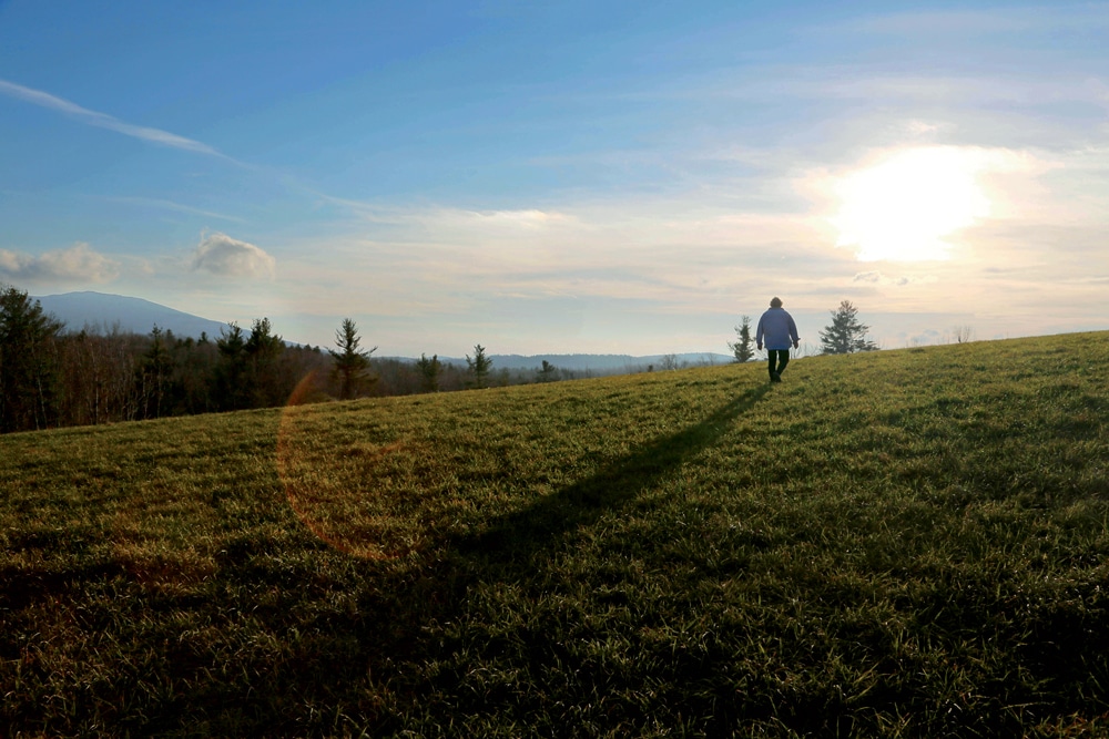 Edie walking the fields by her house. “I sometimes feel like a sentinel,” she wrote, “here to guard the past and guide the future of its open land.”