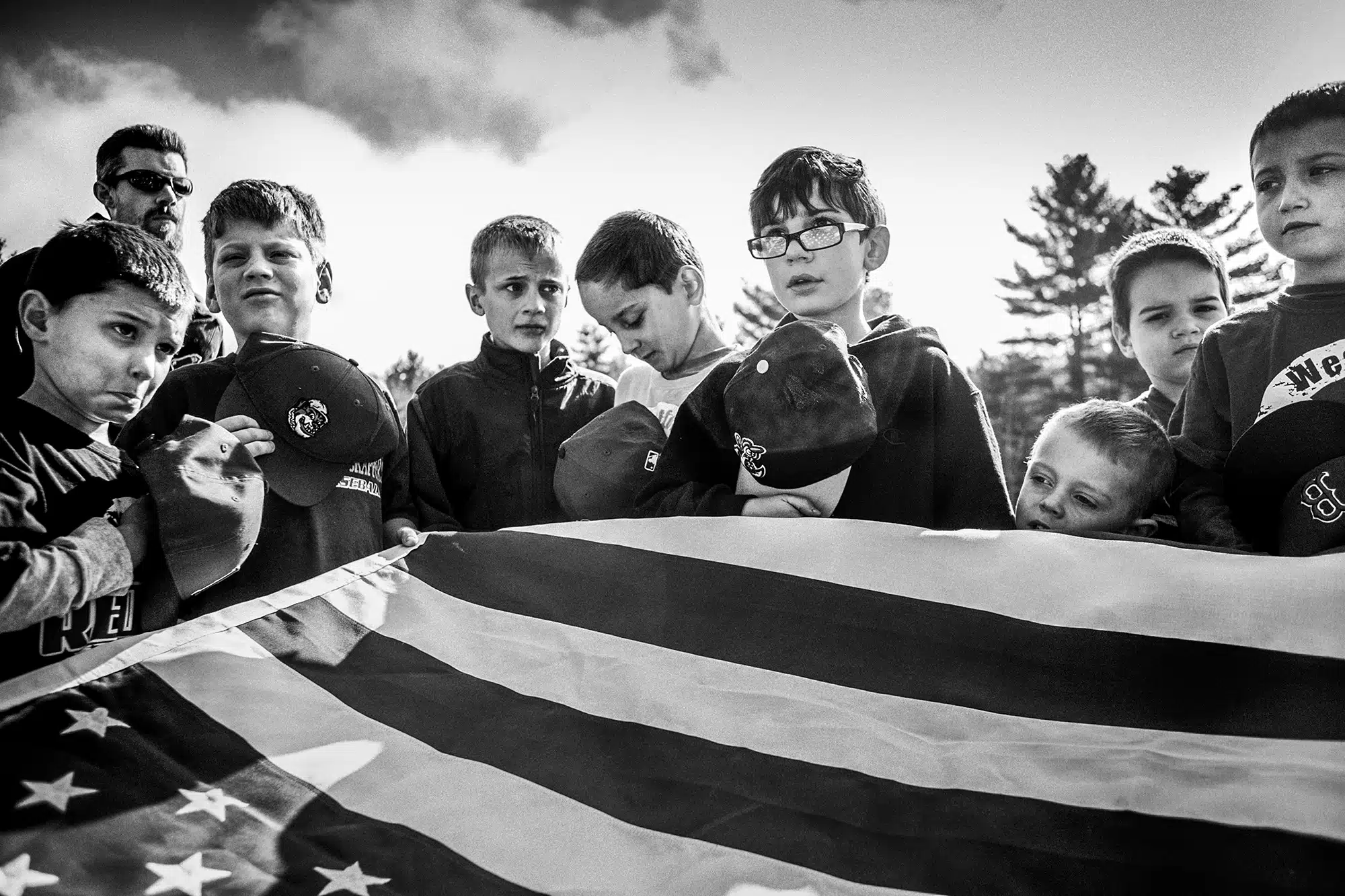 Opening Day - 2015 "This is opening day for little league. The kids are gathered and are to hold the American Flag while The American Anthem is played. I love the disparity of expressions on these boys faces. One is incredibly attentive, while the rest just are goofing off and holding on for dear life until it's over!"