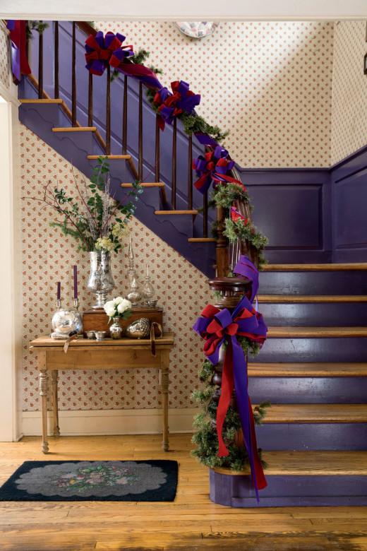 Hardly traditional, the purple foyer “really works at Christmas—all that mercury glass cozied up to the purple and red.” 