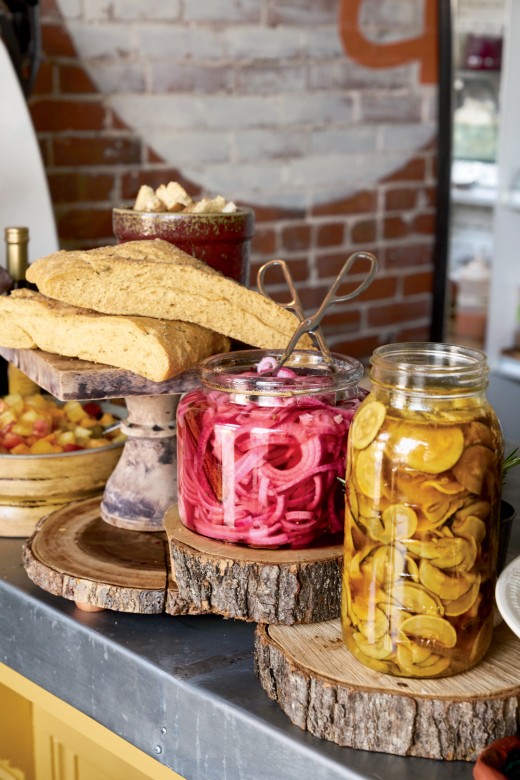 Offerings at the Coop, a café-like nook inside Libby’s Bistro, include butternut focaccia, Middle Eastern pickled onions, and turmeric-ginger pickles.