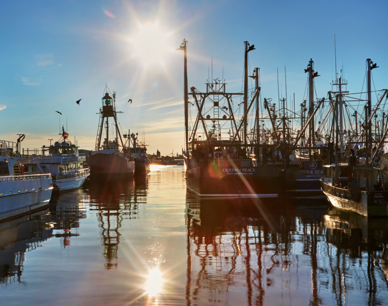 Dawn breaks in New Bedford Harbor, home to the nation’s highest-grossing commercial fishing fleet.