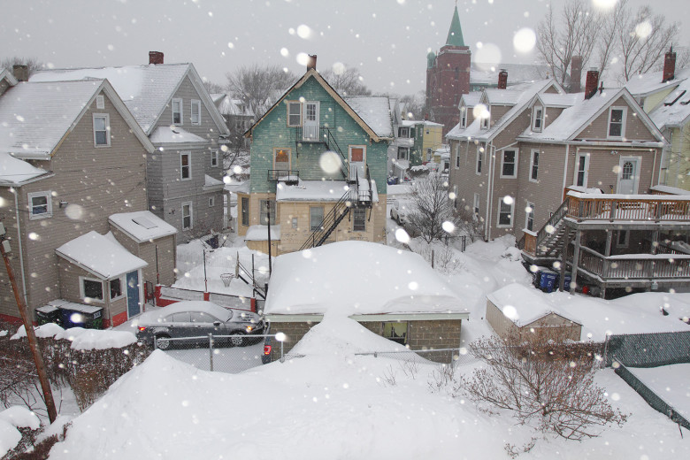 Title: Snowing Again, Storm #4 Location: Somerville, MA. Judge's comments: "This artist photographs the New England landscape from her roof deck in Somerville, Massachusetts. She does it with a bit of whimsy. In a winter of 10-foot snowdrifts, she captures the falling snow that makes this photograph so special. She uses the camera’s built-in flash, which fashions the flakes as large as snowballs and adds some magic to the capture." 