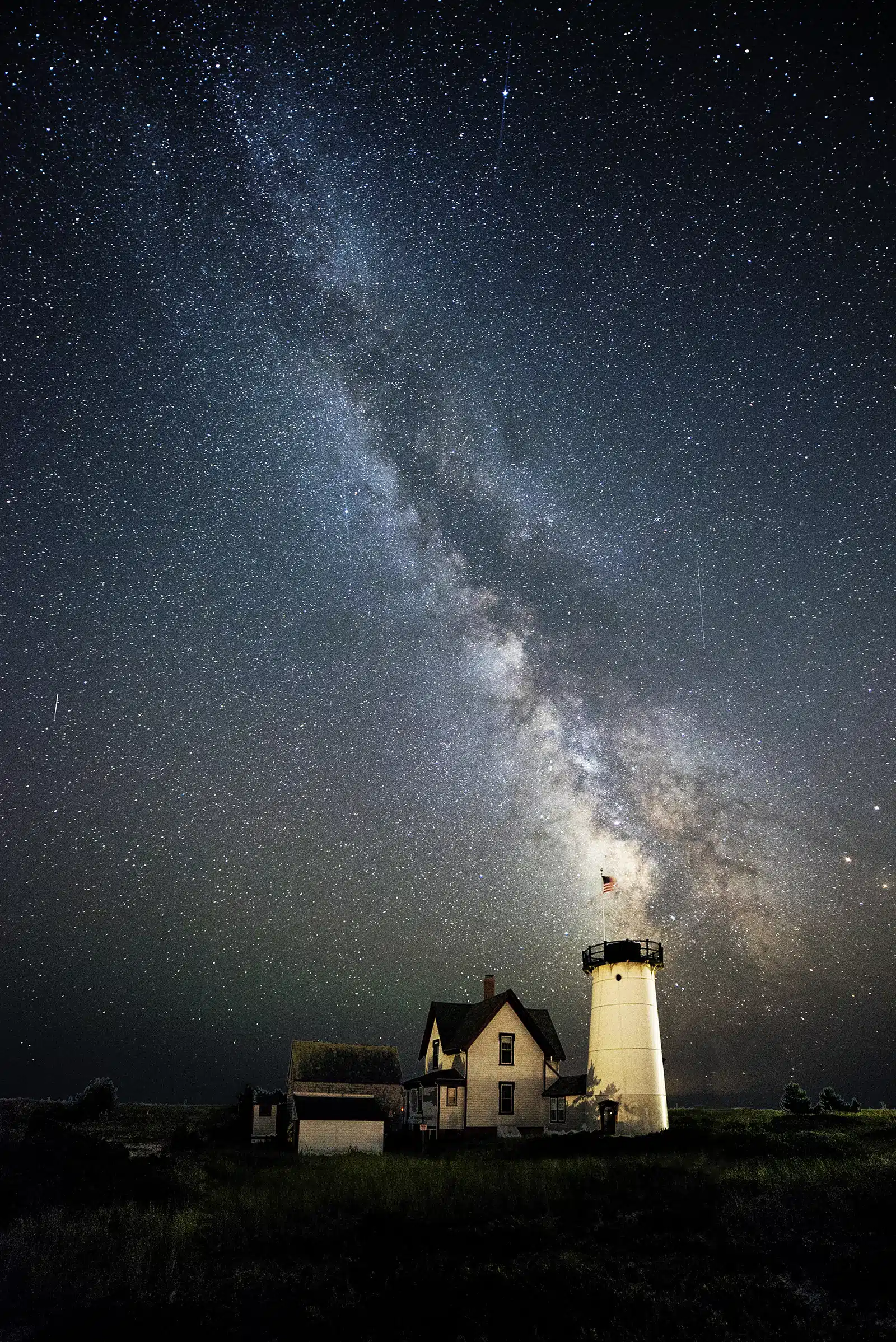 Title: Heavens Above. Location: Stage Harbor Lighthouse, Chatham, MA Judge's comments: "Patience is a skill photographers must hone in order to seize the moments to be shared. Waiting for the sun to drop or for clouds to travel can make all the difference in a photograph. But the photographer must first be able to see potential in the everyday and visualize the outcome. Not all photographs are preplanned, however. Serendipity does exist and the photographer must recognize an opportunity and be able to technically respond before the mystery of the moment slips into oblivion."