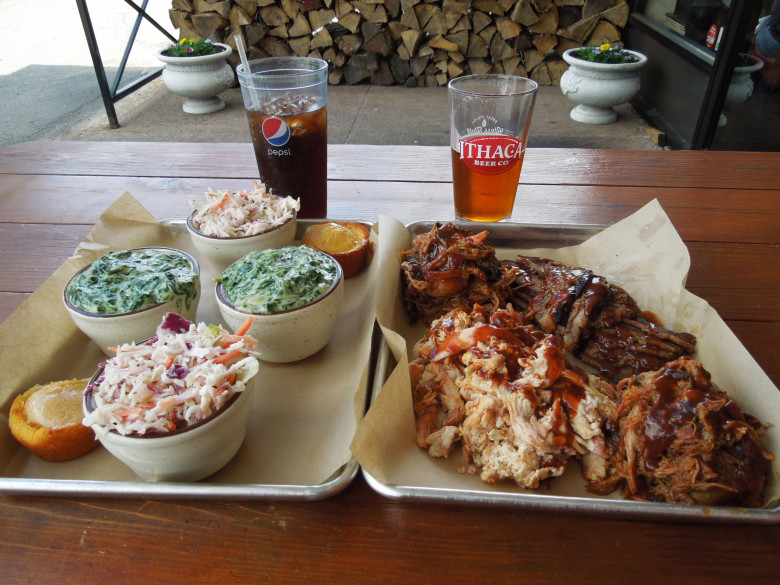 Barbecue for two: a platter of Taino’s smoked meats with creamed spinach, coleslaw, and corn muffins. 