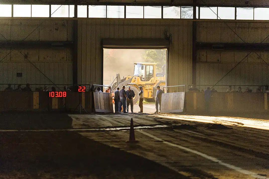 Late afternoon light filters into the arena during the tractor pulls.